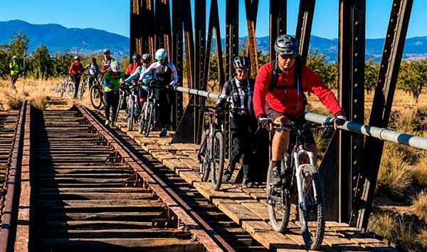 Cyclists crossing a bridge over the Gorafe Desert